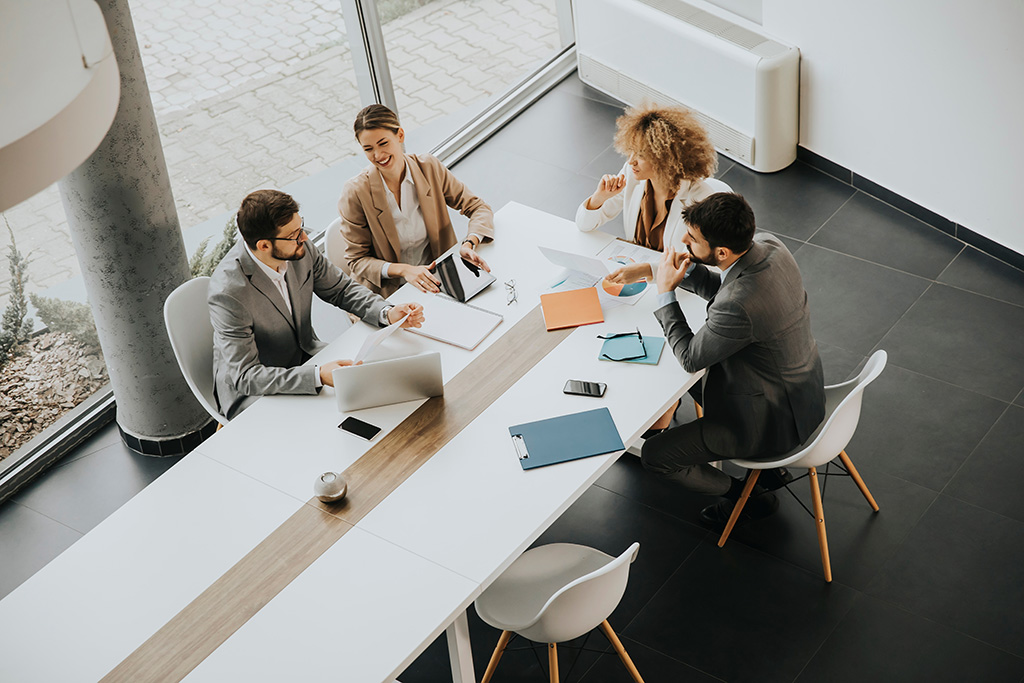 Happy team of coworkers in a clean meeting room